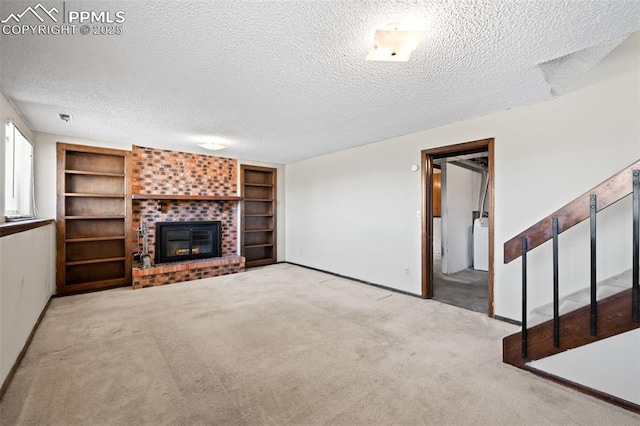 unfurnished living room featuring a textured ceiling, a brick fireplace, carpet floors, baseboards, and washer / dryer
