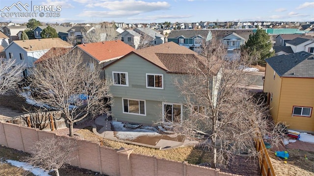 view of front of home featuring a residential view, a patio area, and fence