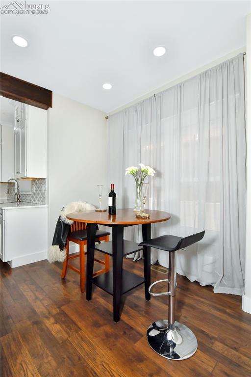 dining area featuring wood finished floors and recessed lighting