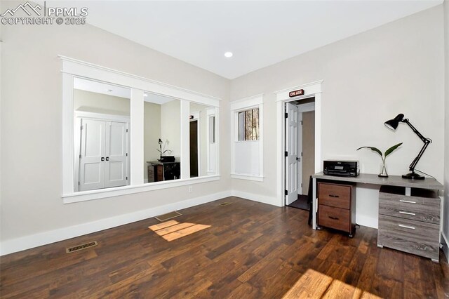 office space featuring recessed lighting, dark wood-style flooring, visible vents, and baseboards