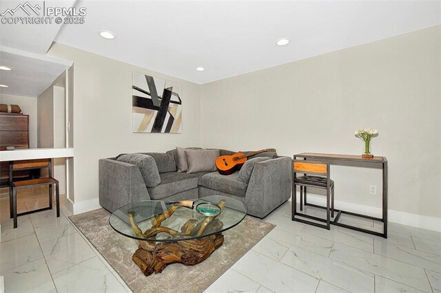 living room featuring recessed lighting, marble finish floor, and baseboards