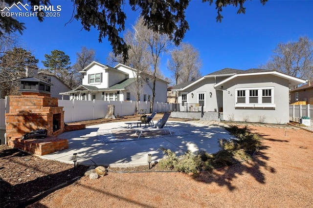 rear view of house with a patio area, a fenced backyard, a residential view, and stucco siding