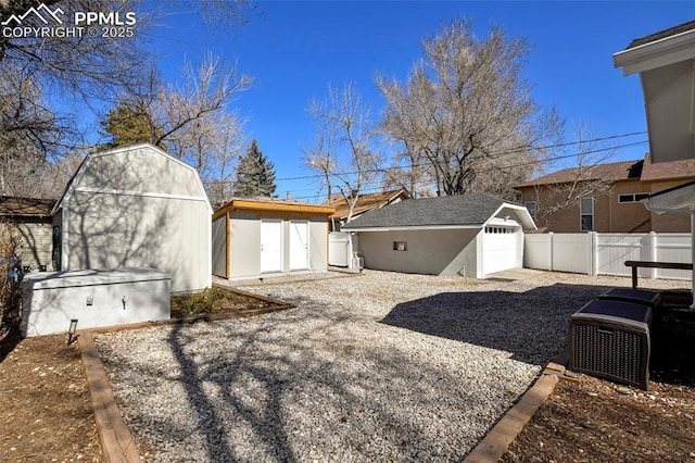 view of yard featuring fence and an outdoor structure