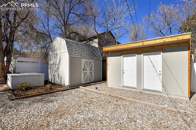 view of shed featuring fence