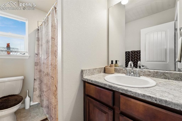 full bathroom with toilet, tile patterned floors, and vanity