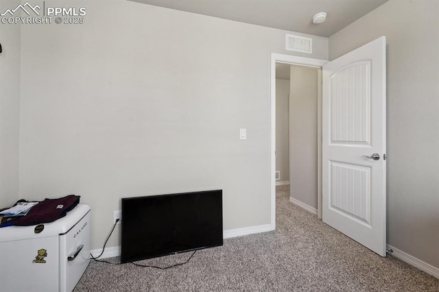 unfurnished bedroom featuring baseboards, visible vents, and carpet flooring