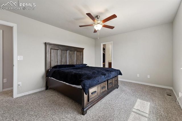 carpeted bedroom featuring ceiling fan, a spacious closet, and baseboards