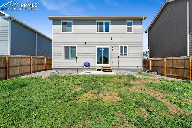 rear view of property featuring entry steps, a fenced backyard, a patio, and a lawn