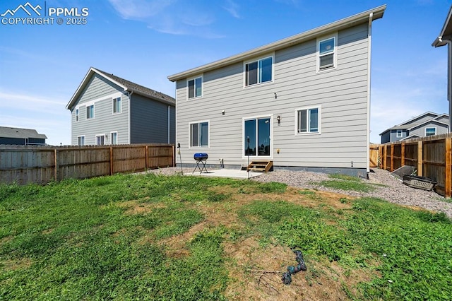 back of property with entry steps, a patio area, and a fenced backyard