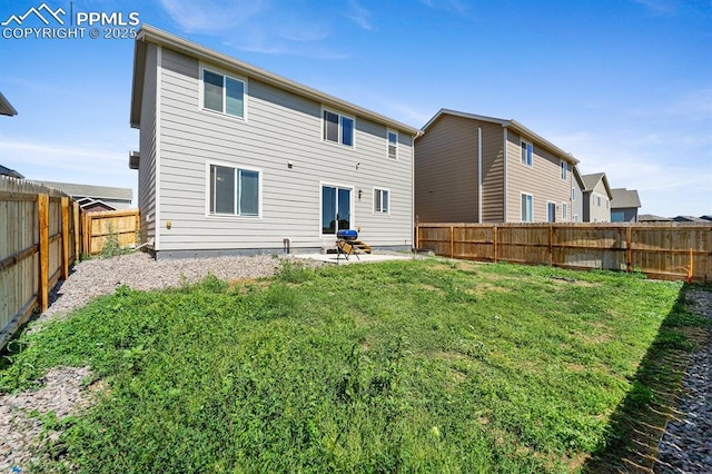 rear view of property with a patio area, a fenced backyard, and a yard