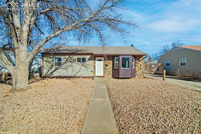 ranch-style house featuring fence