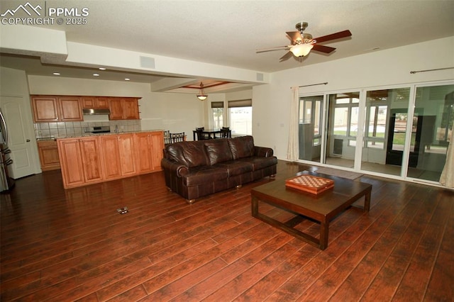 living room featuring dark wood-style floors, ceiling fan, visible vents, and recessed lighting