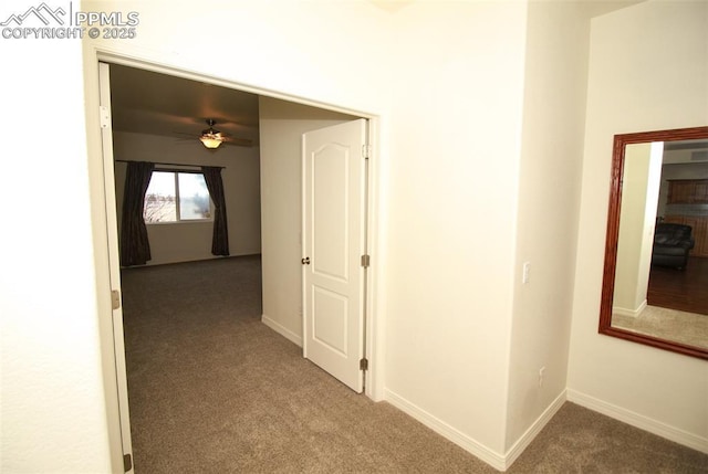 hallway with carpet and baseboards