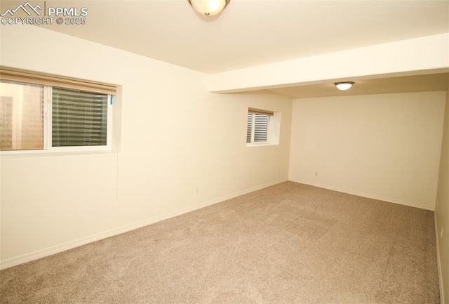 carpeted spare room with baseboards