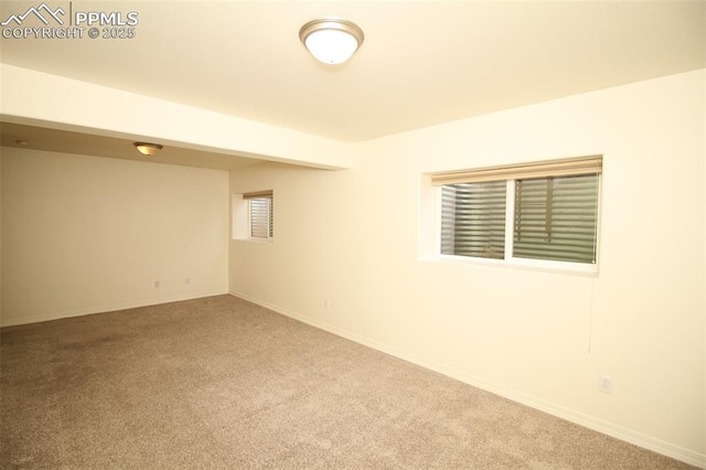 empty room with carpet and baseboards