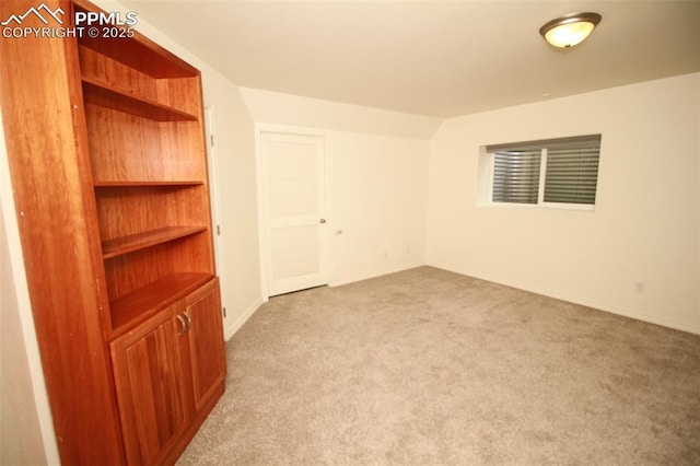 carpeted empty room with baseboards