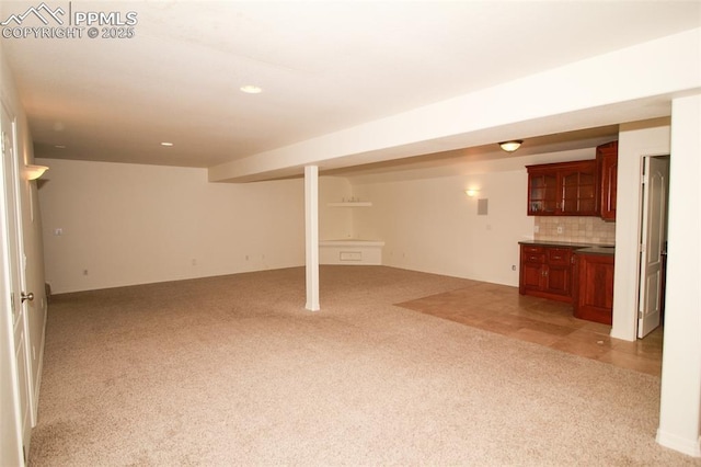 finished basement featuring light carpet and recessed lighting