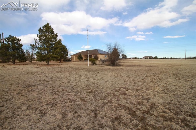 view of yard with a rural view