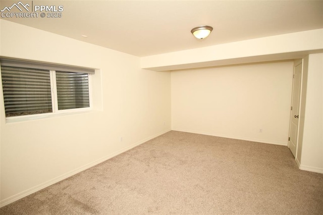 unfurnished room featuring carpet floors and baseboards