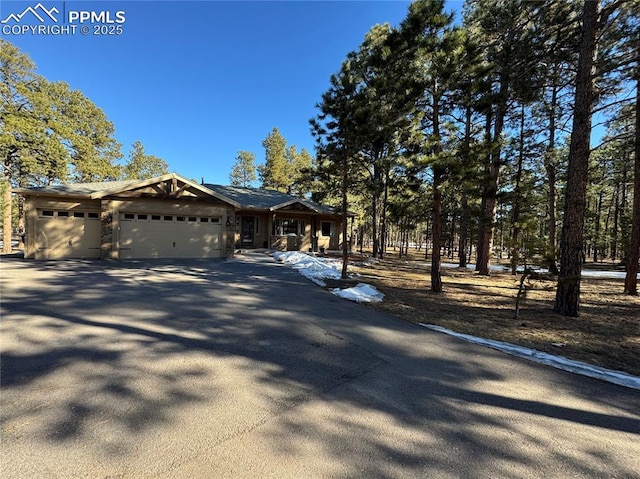 view of front of house featuring a garage and aphalt driveway