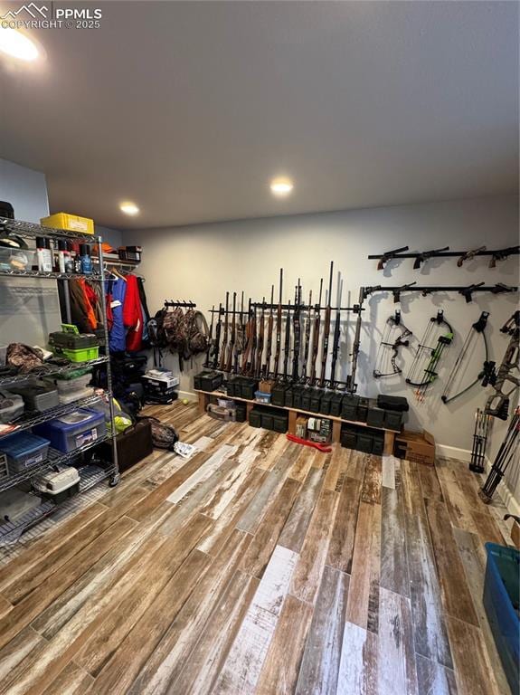 workout area featuring wood finished floors and baseboards