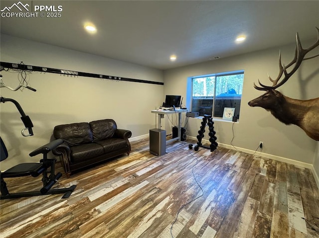 exercise area with recessed lighting, wood finished floors, visible vents, and baseboards