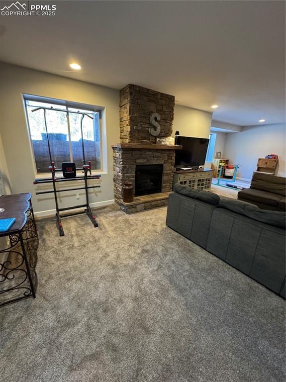 carpeted living room featuring recessed lighting, a stone fireplace, and baseboards