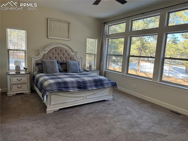 carpeted bedroom featuring baseboards, visible vents, and ceiling fan