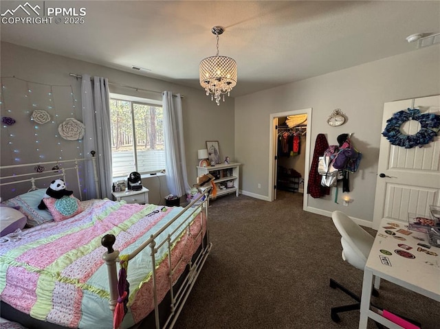 bedroom featuring a notable chandelier, visible vents, baseboards, a spacious closet, and dark carpet