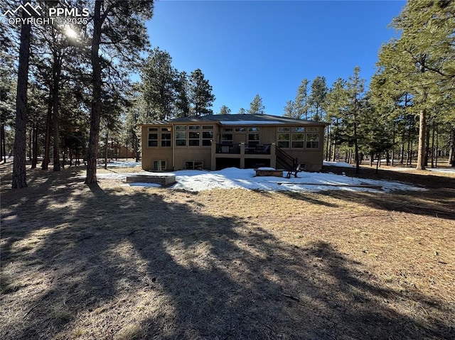 rear view of house with a sunroom and stairway