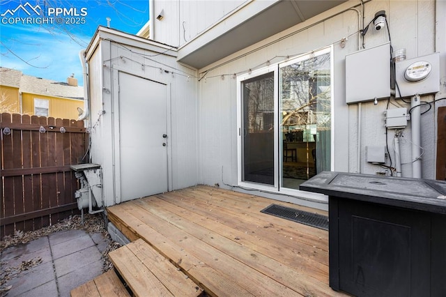 wooden terrace featuring fence