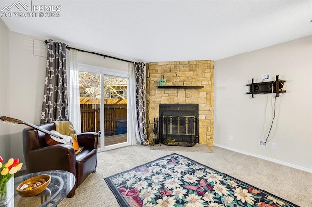 carpeted living area featuring a fireplace, baseboards, and a textured ceiling