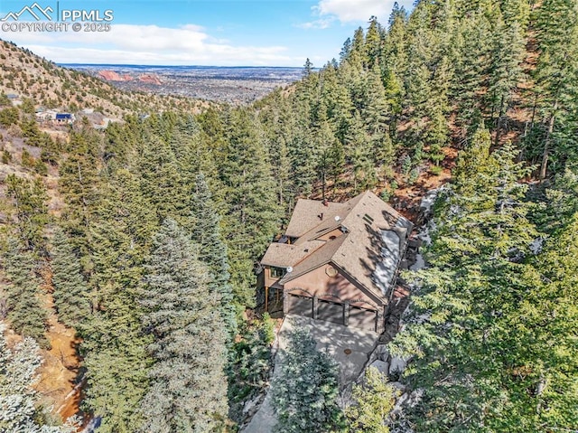 birds eye view of property with a wooded view