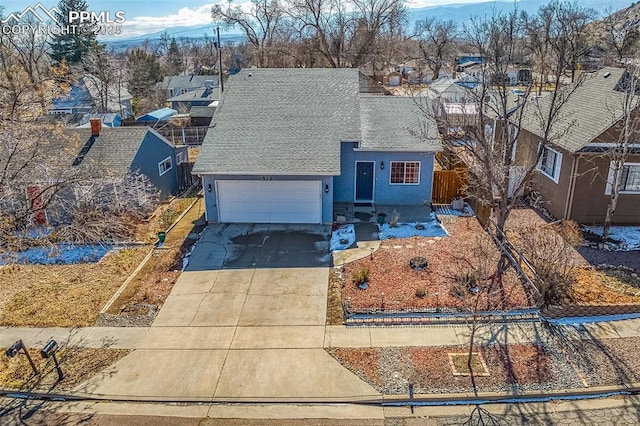 view of front of house with a garage, a residential view, driveway, and stucco siding