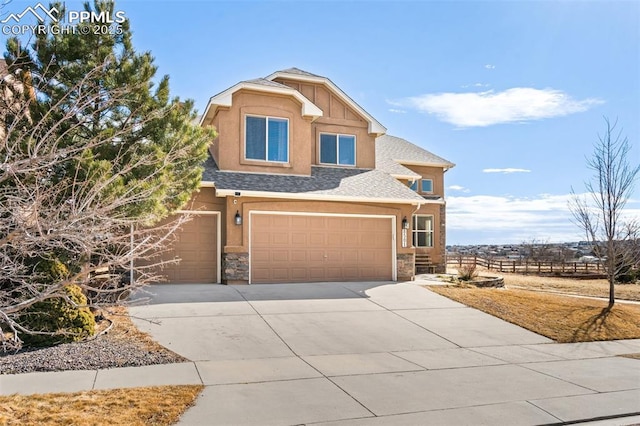 view of front of home with an attached garage, a shingled roof, fence, driveway, and stone siding