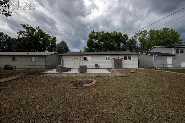 rear view of house with a patio area, fence, an outdoor structure, and a yard