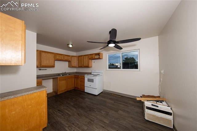 kitchen with white range with electric cooktop, dark wood finished floors, a ceiling fan, brown cabinets, and a sink