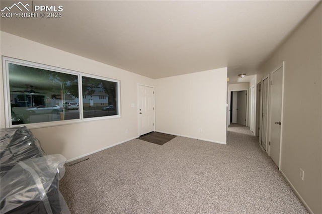 interior space with carpet and baseboards