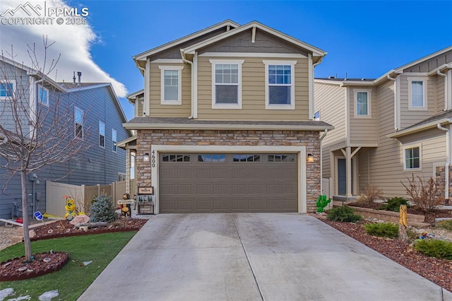 craftsman inspired home with an attached garage, stone siding, fence, and concrete driveway