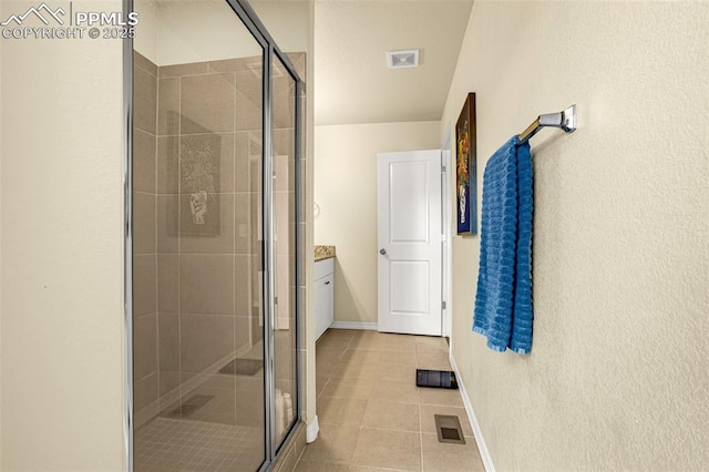 bathroom featuring a stall shower, visible vents, and tile patterned floors