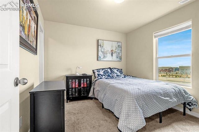 bedroom featuring carpet flooring and visible vents