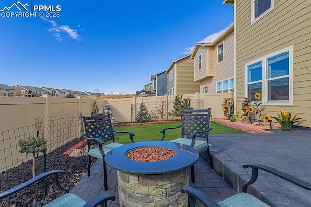 view of patio / terrace featuring a residential view, a fenced backyard, and a fire pit