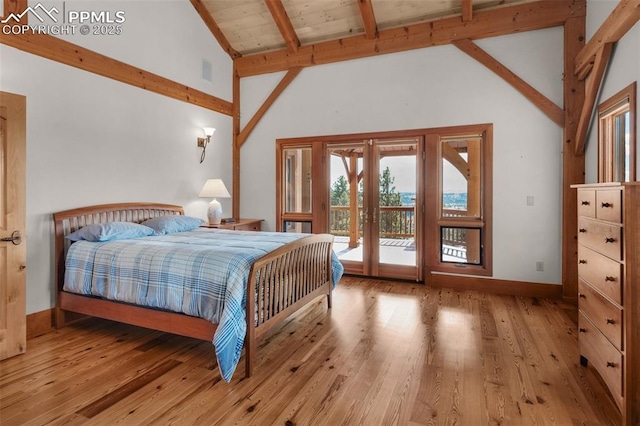 bedroom with access to exterior, beam ceiling, french doors, wood finished floors, and baseboards