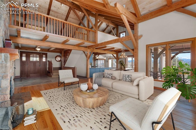 living room featuring high vaulted ceiling, wood ceiling, wood finished floors, a chandelier, and beamed ceiling