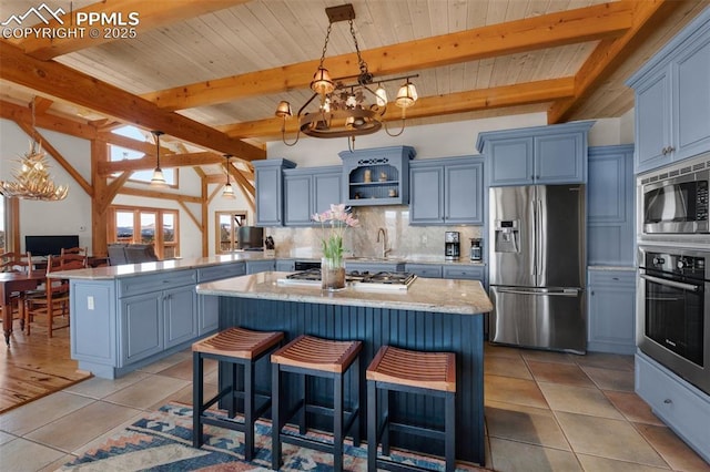 kitchen featuring a chandelier, stainless steel appliances, tasteful backsplash, and light tile patterned floors