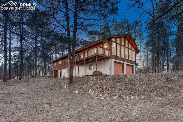 exterior space featuring a garage and a deck