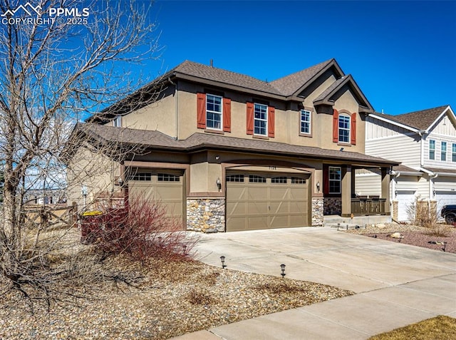 view of front facade with stone siding, concrete driveway, an attached garage, and stucco siding