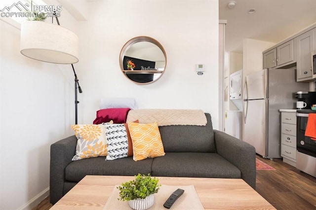 living room with baseboards and dark wood-type flooring