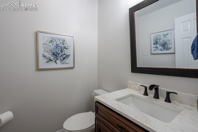 bathroom featuring toilet and vanity