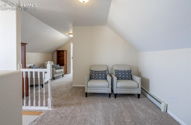 sitting room featuring carpet, a baseboard radiator, lofted ceiling, and baseboards